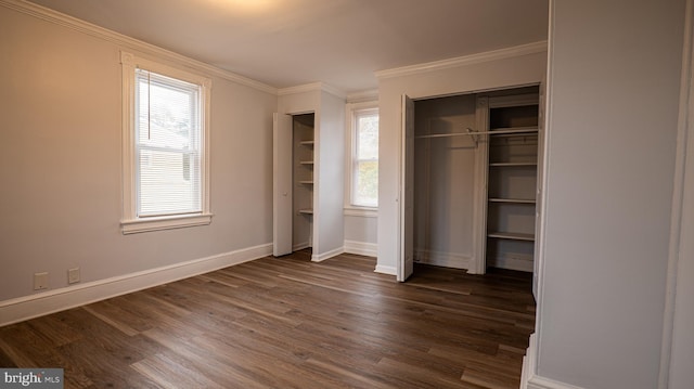 unfurnished bedroom with crown molding, dark hardwood / wood-style flooring, and multiple windows