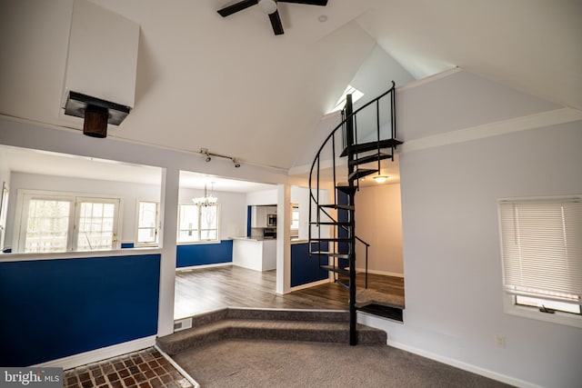 interior space featuring high vaulted ceiling, ceiling fan with notable chandelier, and hardwood / wood-style flooring