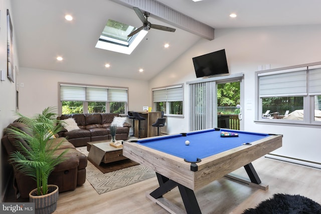 playroom with a skylight, billiards, beam ceiling, and light hardwood / wood-style flooring