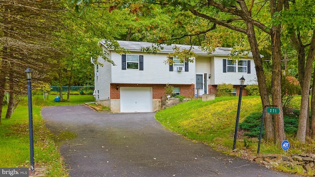 split foyer home with a front yard and a garage