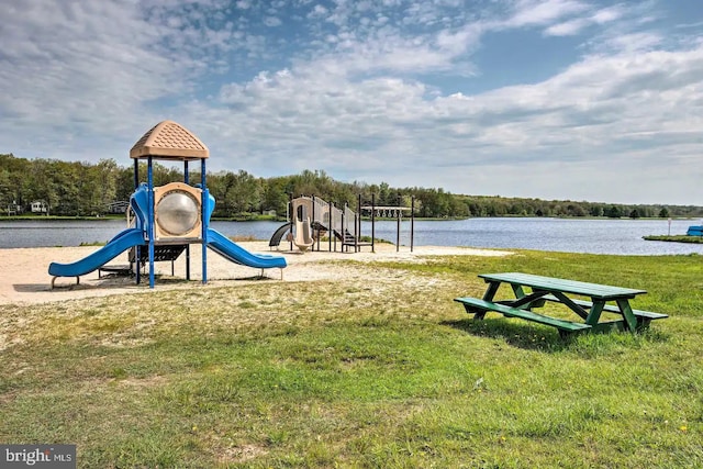 view of play area with a water view and a yard