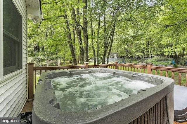 wooden deck featuring a hot tub