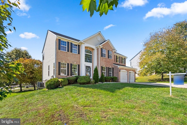 view of front of home featuring a front yard, a garage, and central AC unit