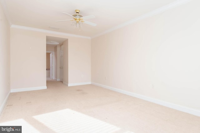 carpeted spare room featuring ceiling fan and crown molding