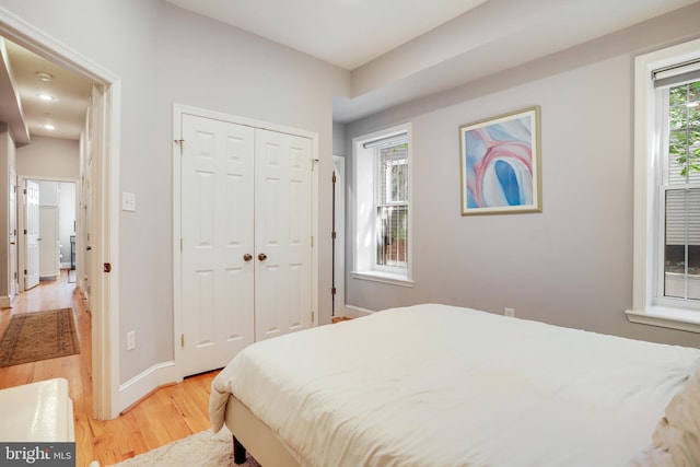 bedroom featuring light wood-type flooring and a closet