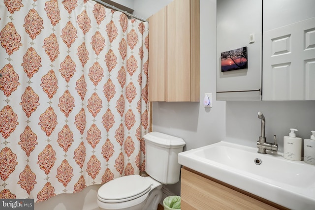 bathroom featuring vanity, hardwood / wood-style floors, toilet, and a shower with shower curtain