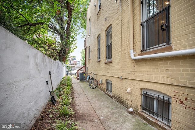 view of side of home with central AC