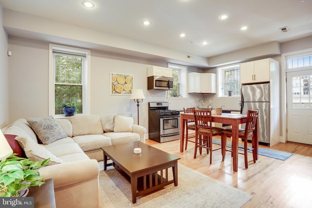 living room with light hardwood / wood-style flooring