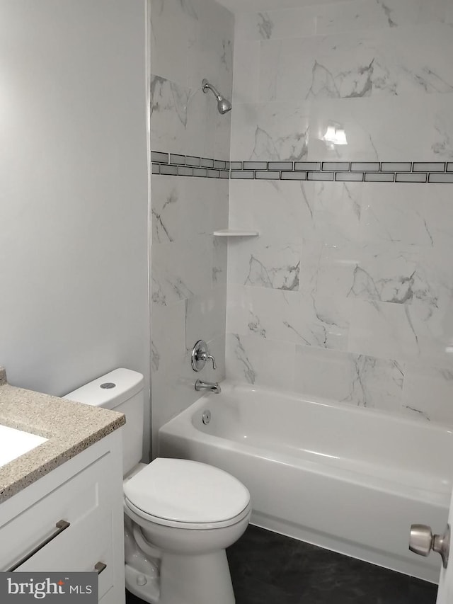 full bathroom featuring tiled shower / bath, vanity, and toilet