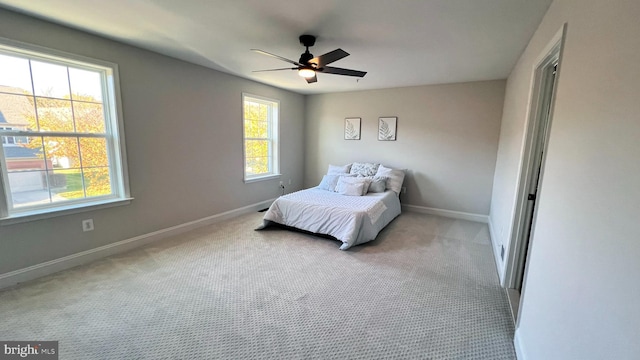 bedroom featuring ceiling fan and light colored carpet