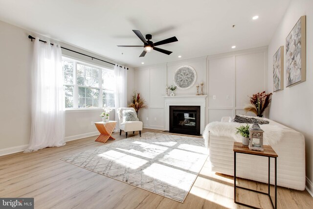 sitting room featuring light hardwood / wood-style floors and ceiling fan