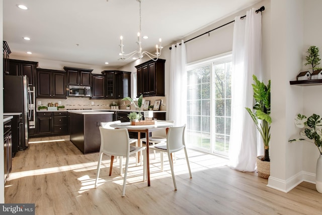 kitchen featuring dark brown cabinets, stainless steel appliances, light hardwood / wood-style floors, and tasteful backsplash