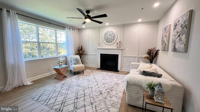 sitting room with light hardwood / wood-style flooring and ceiling fan