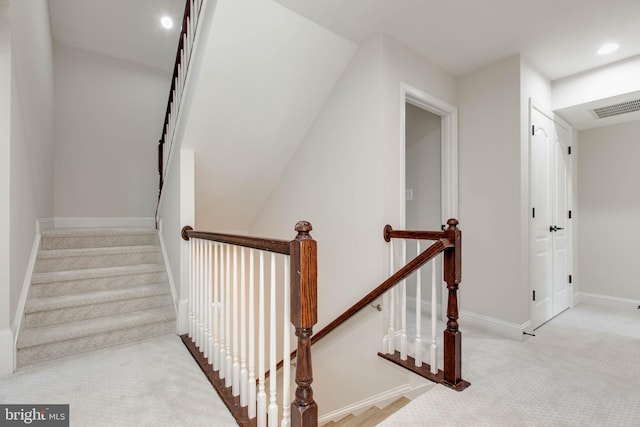 stairs featuring carpet flooring