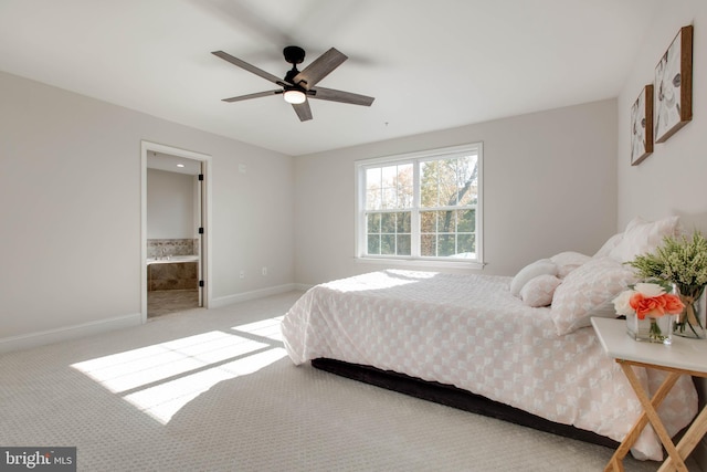 carpeted bedroom featuring ensuite bathroom and ceiling fan