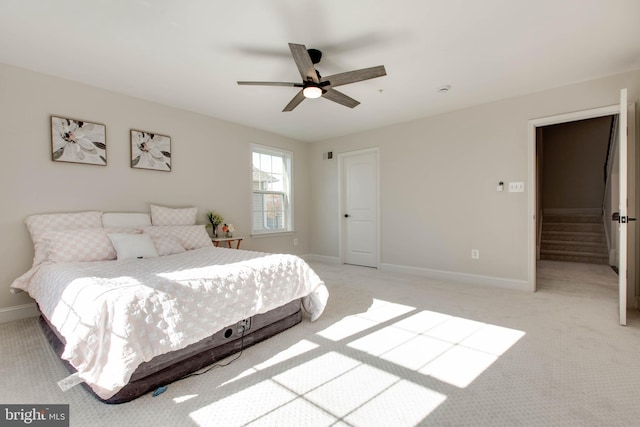 bedroom featuring light colored carpet and ceiling fan