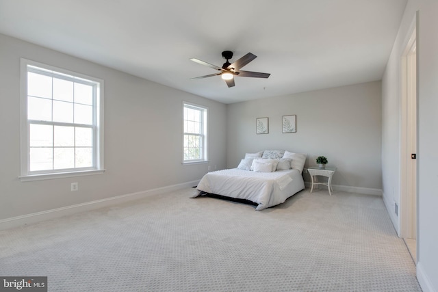 bedroom with ceiling fan and light colored carpet