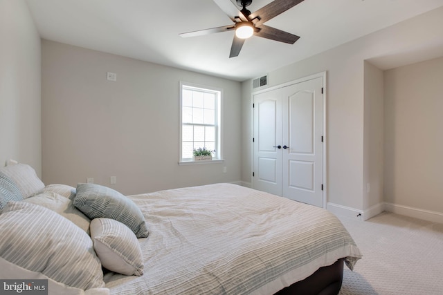 carpeted bedroom with a closet and ceiling fan