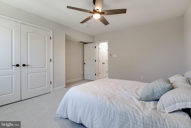 bedroom featuring a closet, ceiling fan, and light carpet