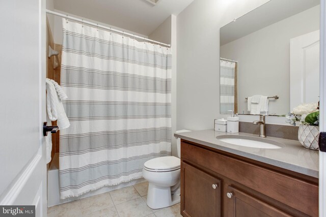 bathroom with vanity, toilet, and tile patterned floors