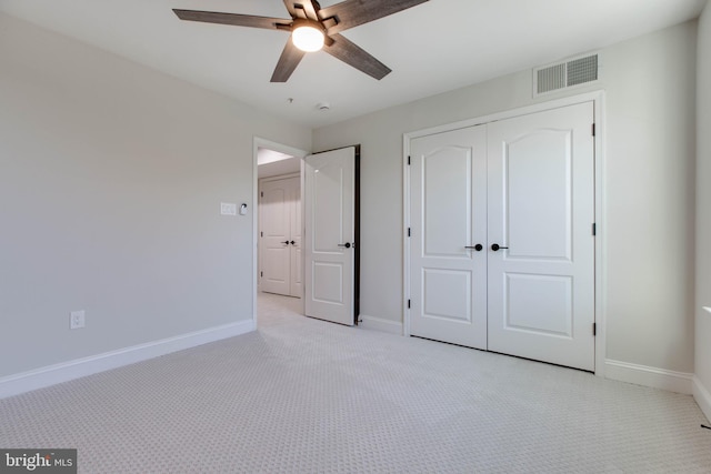 unfurnished bedroom featuring a closet, ceiling fan, and light carpet