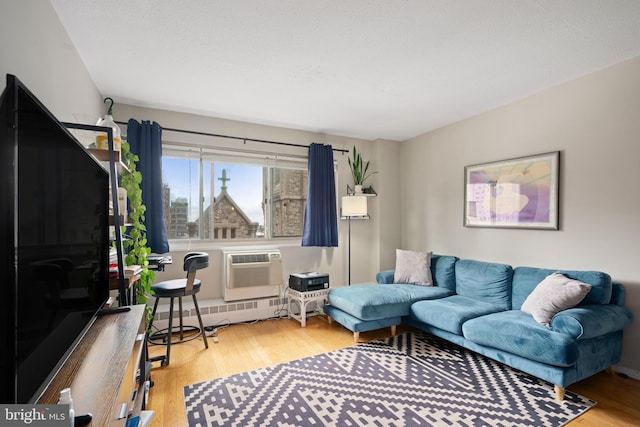 living room with a wall mounted AC and hardwood / wood-style flooring