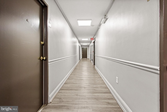 corridor with light hardwood / wood-style flooring