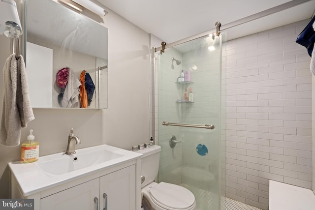 bathroom with vanity, toilet, and an enclosed shower