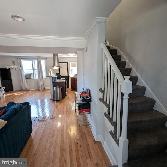 stairs featuring wood-type flooring, ornamental molding, and cooling unit