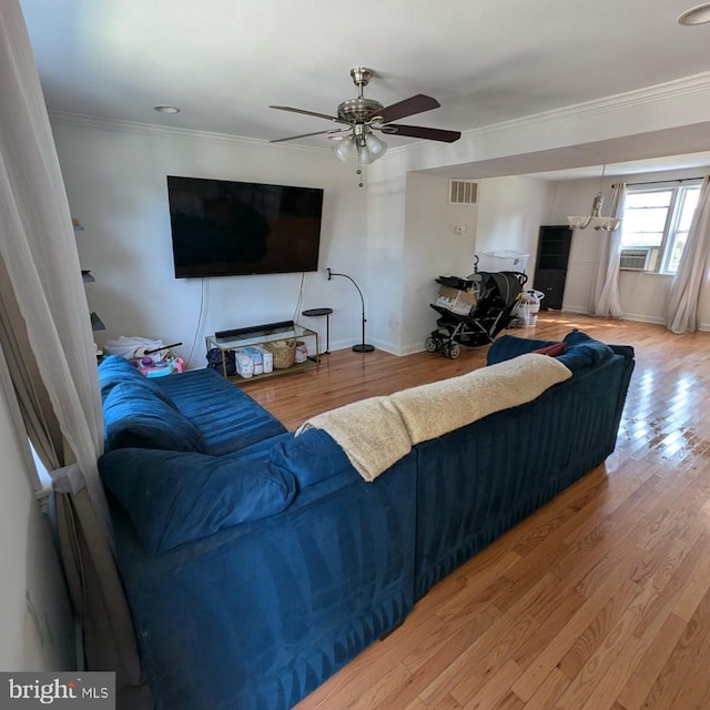 living room featuring crown molding, ceiling fan, hardwood / wood-style floors, and cooling unit