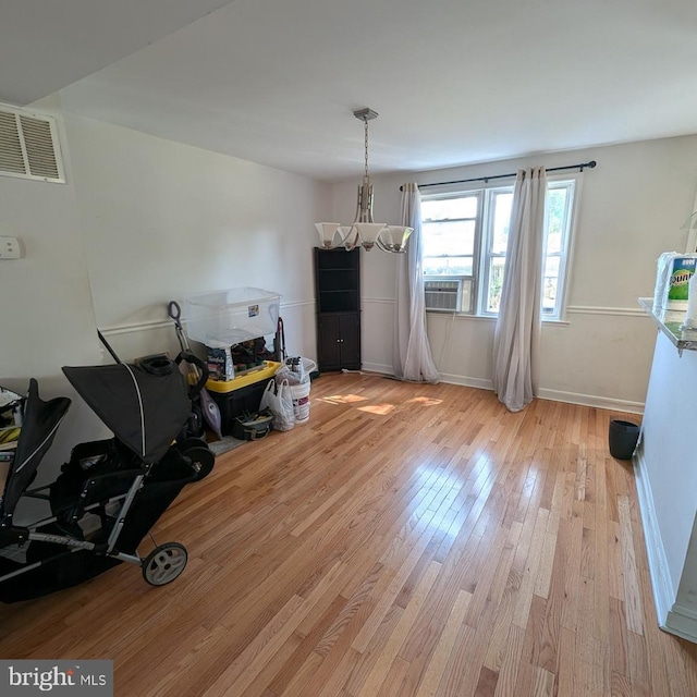 dining room featuring cooling unit and light hardwood / wood-style flooring