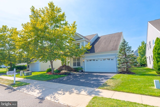 view of front of home with a garage and a front lawn