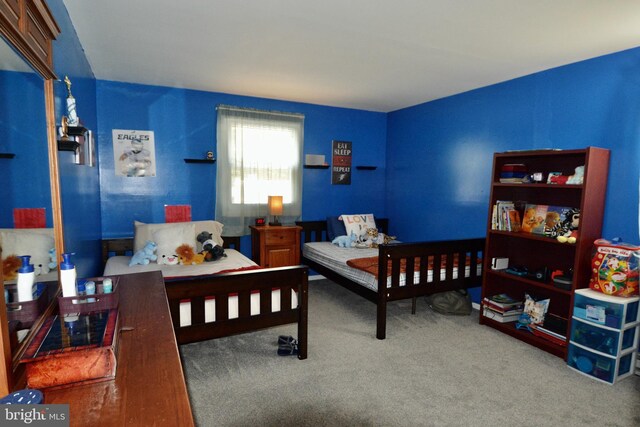 bedroom featuring multiple windows and light colored carpet