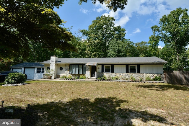 single story home featuring a front yard and a garage