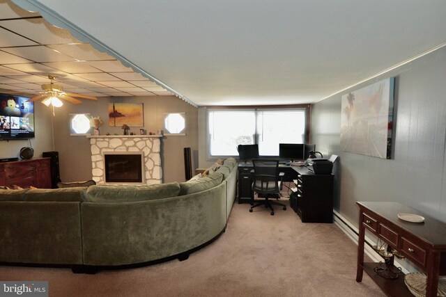 interior details with a stone fireplace, wood-type flooring, and a drop ceiling