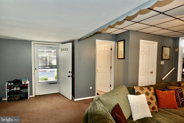 carpeted living room featuring a paneled ceiling, ceiling fan, baseboard heating, and a fireplace