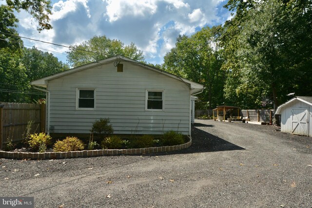 view of home's exterior with a storage unit