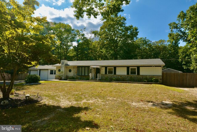 ranch-style home with a garage and a front yard