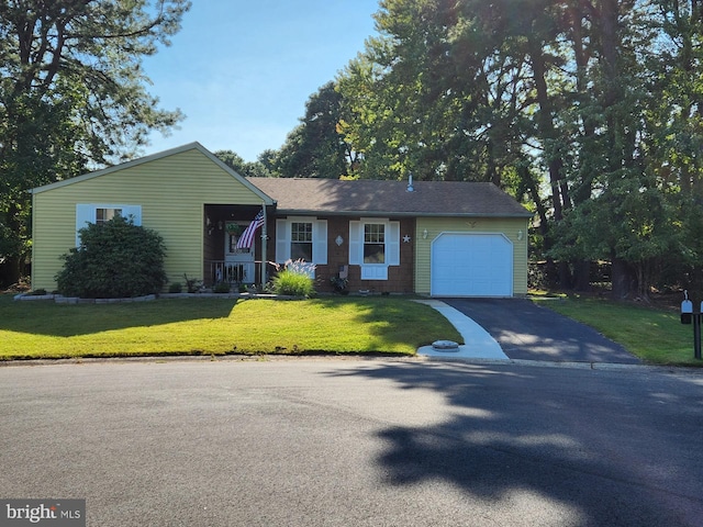 view of front of property with a garage, covered porch, and a front lawn