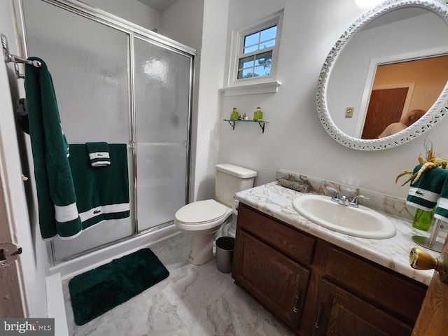 bathroom featuring walk in shower, toilet, and vanity