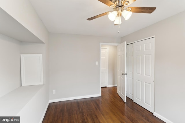 unfurnished room featuring ceiling fan and dark hardwood / wood-style flooring