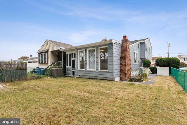 back of house with a lawn