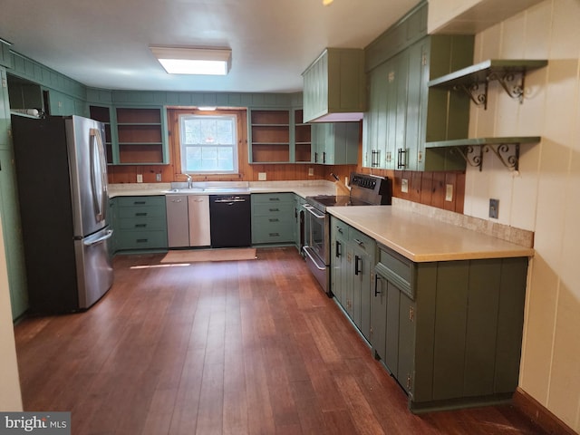 kitchen with dark wood-type flooring, stainless steel appliances, sink, and green cabinets