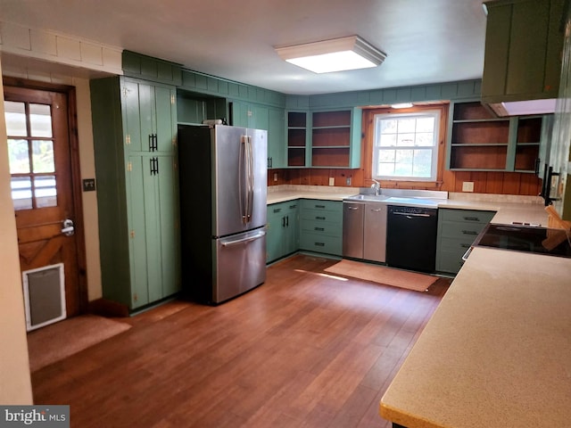 kitchen with stainless steel fridge, dishwasher, light hardwood / wood-style flooring, green cabinets, and sink