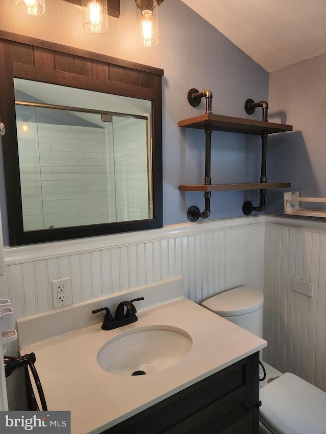 bathroom with vanity, toilet, and an enclosed shower