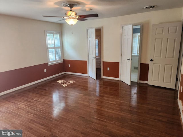 spare room featuring ceiling fan and dark hardwood / wood-style floors