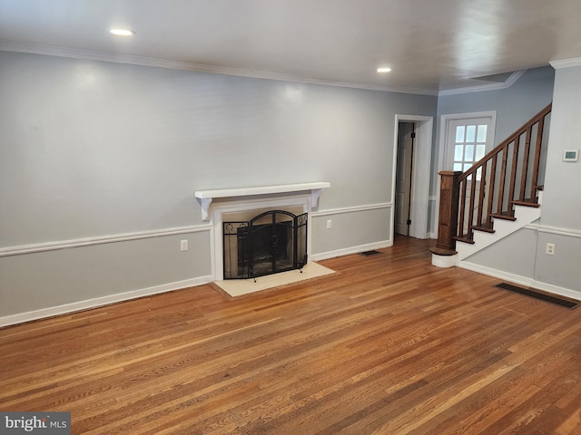 unfurnished living room featuring crown molding and wood-type flooring