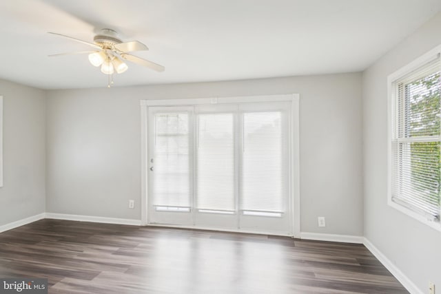 unfurnished room with ceiling fan and dark hardwood / wood-style flooring