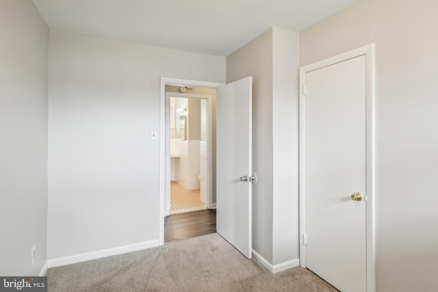 unfurnished bedroom featuring light colored carpet