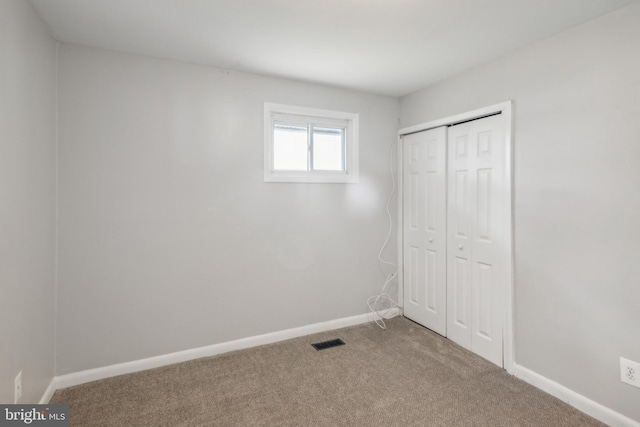 unfurnished bedroom with carpet flooring and a closet